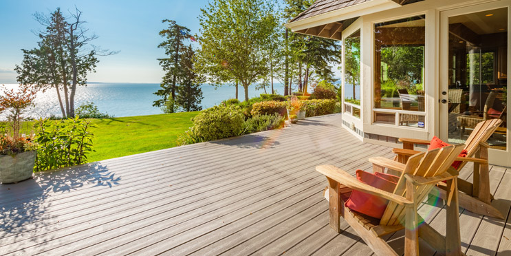Terrasse mit Gartenstühlen und Ausblick auf Wasser
